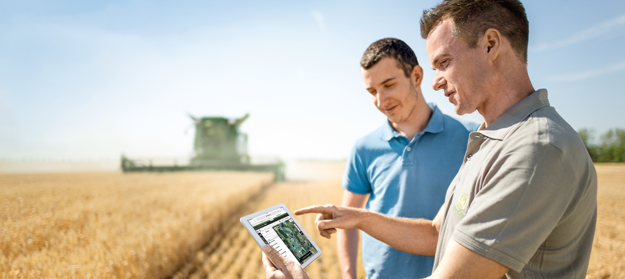 Looking at a tablet in the corn field.