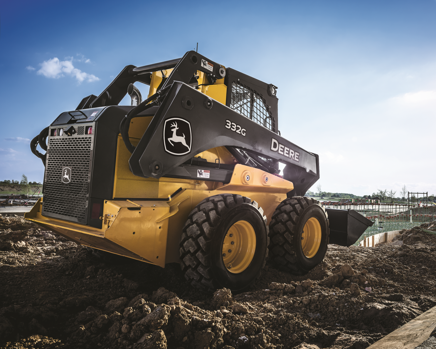 John Deere Skid Steer is working on the field